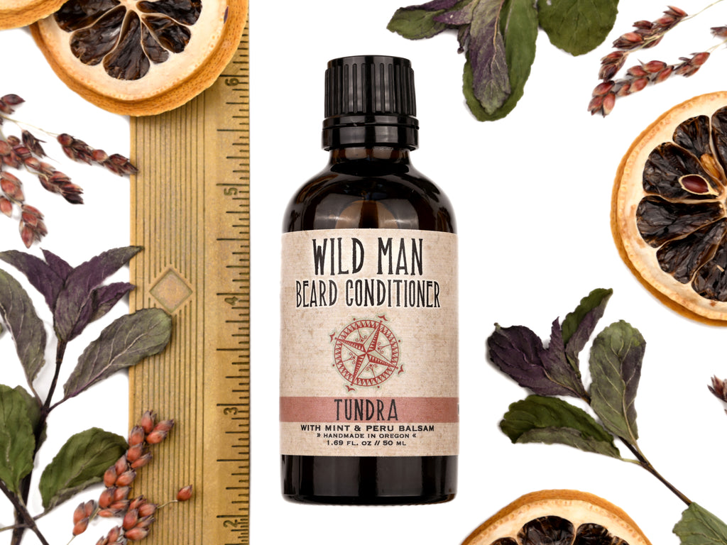Wild Man Beard Oil Conditioner Tundra scent in 50ml amber glass bottle. Show with ruler at about 4" tall.  Lemon slices and peppermint leaves surround.