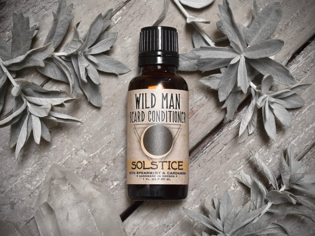 Wild Man Beard Oil Conditioner Solstice in 30ml amber glass bottle. Mugwort leaves and quartz crystals surround.