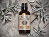 Wild Man Beard Oil Conditioner Solstice in 50ml amber glass bottle. Mugwort leaves and quartz crystals surround.