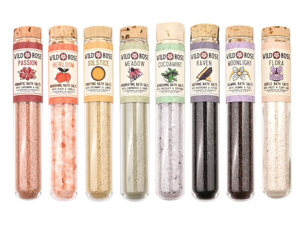 Botanical Bath Salts from Wild Rose in glass test tubes arranged in rainbow order.