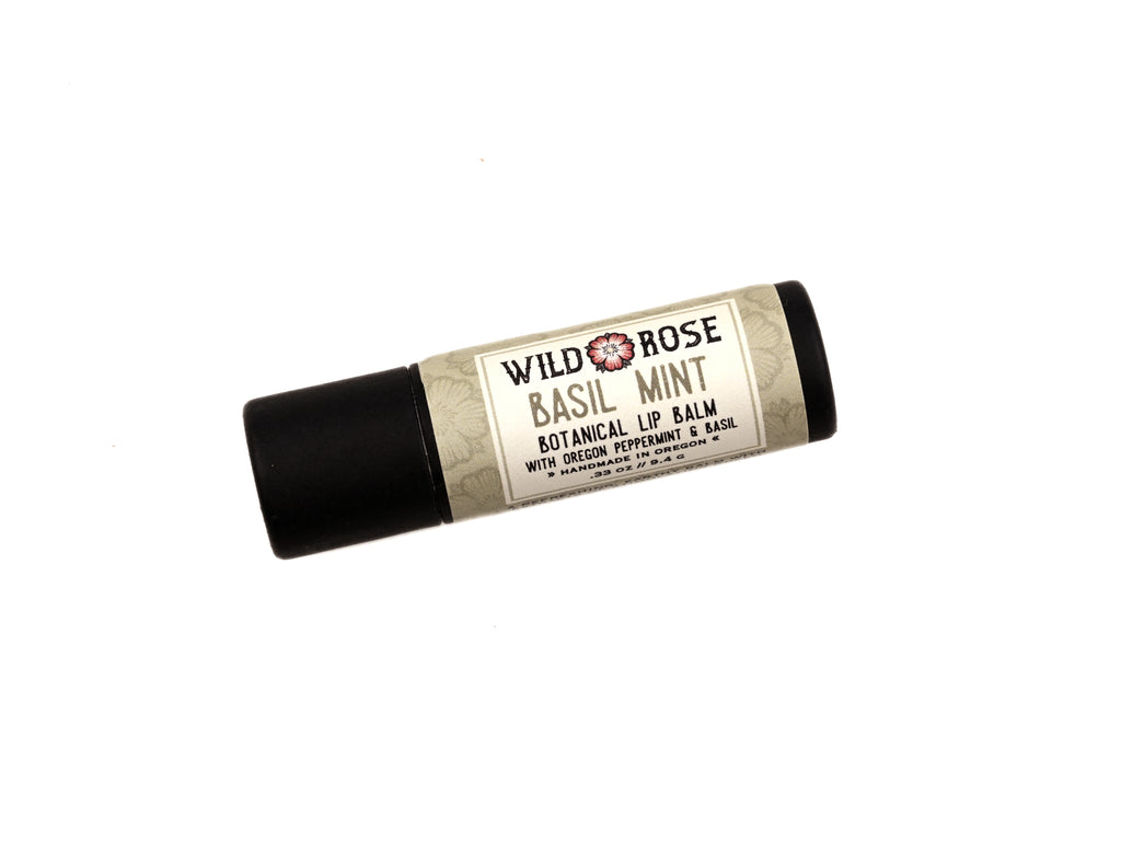 Basil Mint Natural Lip Balm in a biodegradable paper tube on a white background.