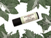 Catnip Natural Lip Balm in a biodegradable paper tube. Dried catnip leaves surround.