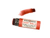 Wild Rose Cherry Vanilla Botanical Lip & Cheek Tint in a biodegradable tube on a white background. The cap is removed revealing a dark red creamy tinted balm.