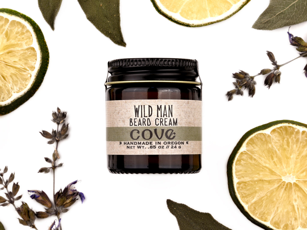 Wild Man Beard Cream Cove scent in 1oz amber jar. Lime slices and sage leaves surround.