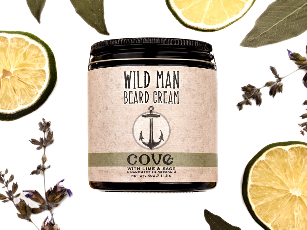 Wild Man Beard Cream Cove scent in 4oz amber jar. Lime slices and sage leaves surround.