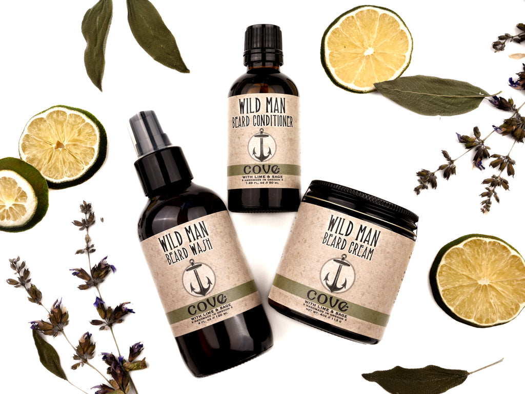 Wild Man beard care set in Cove scent with 50ml Beard Conditioner, 4oz Beard Wash and 4oz Beard Cream. Lime slices and sage leaves surround.
