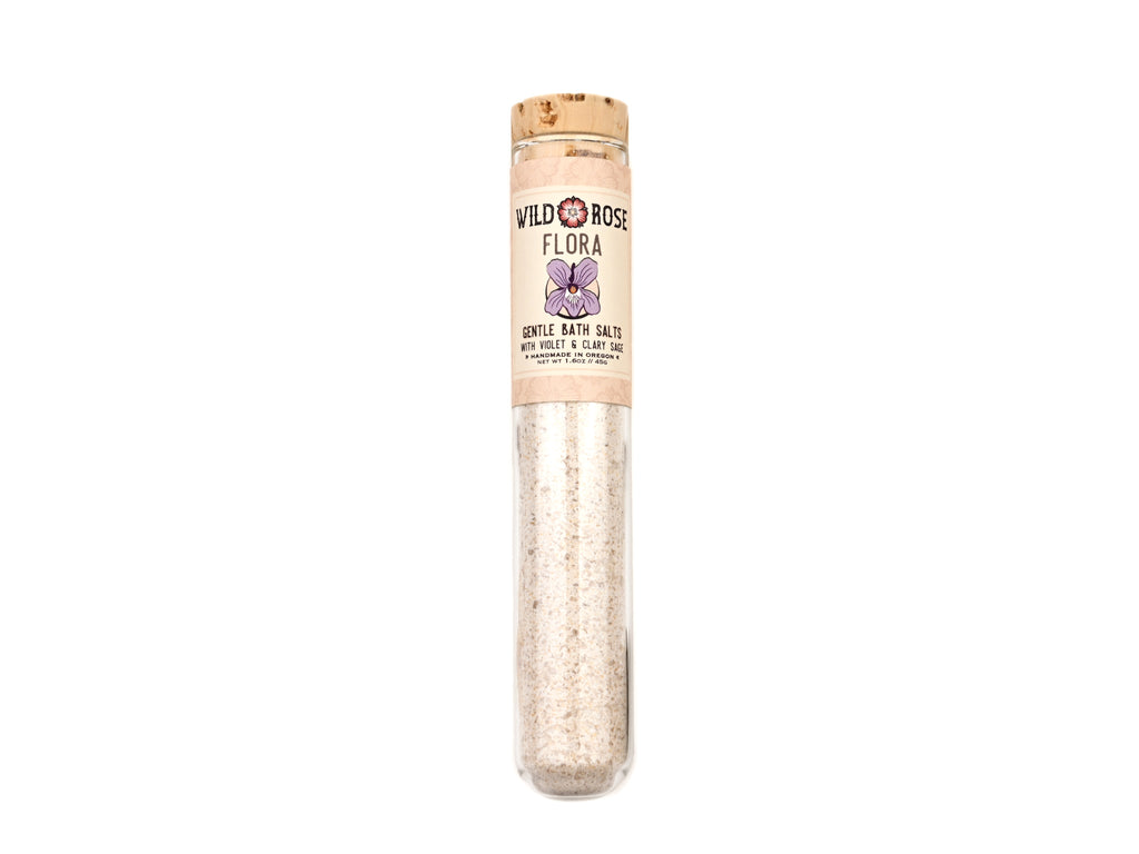 Flora Gentle Bath Salts in a glass test tube on a white background.