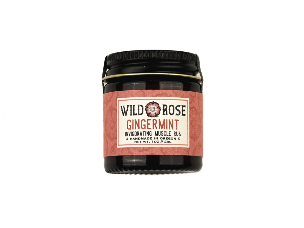 Gingermint Muscle Rub in a 1oz amber gladd jar with metal lid on white background.