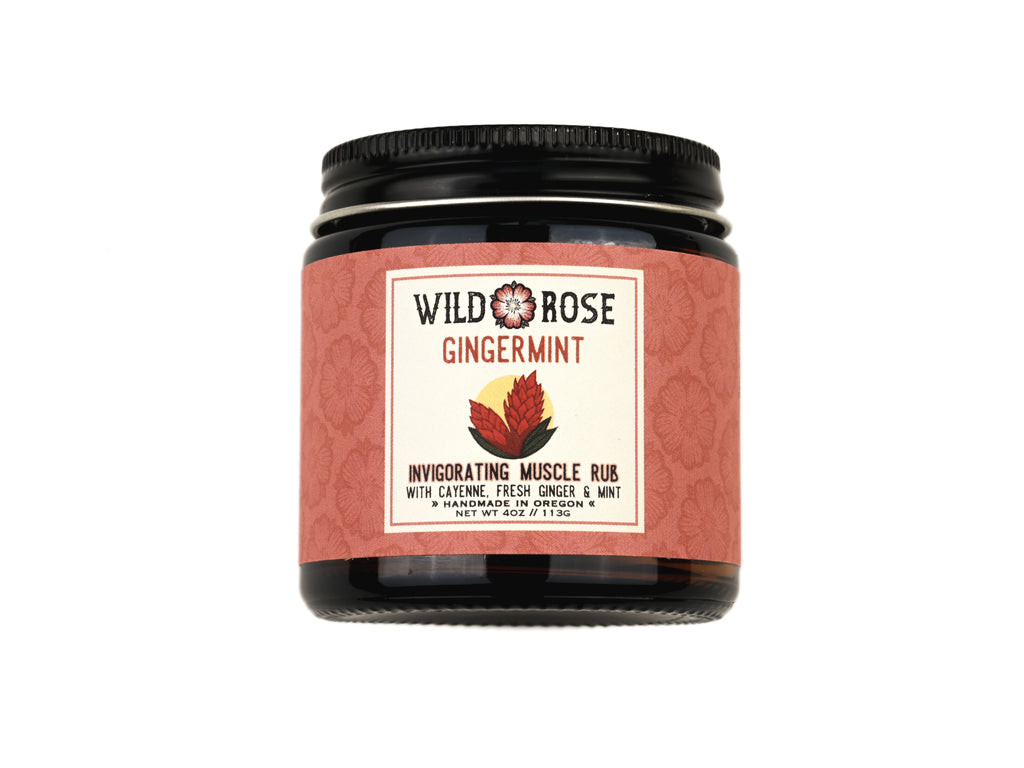 Gingermint Muscle Rub in a 4oz amber gladd jar with metal lid on white background.