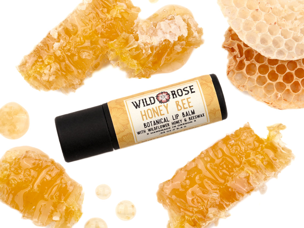 Honey Bee Natural Lip Balm in a biodegradable paper tube. Honey comb surrounds.