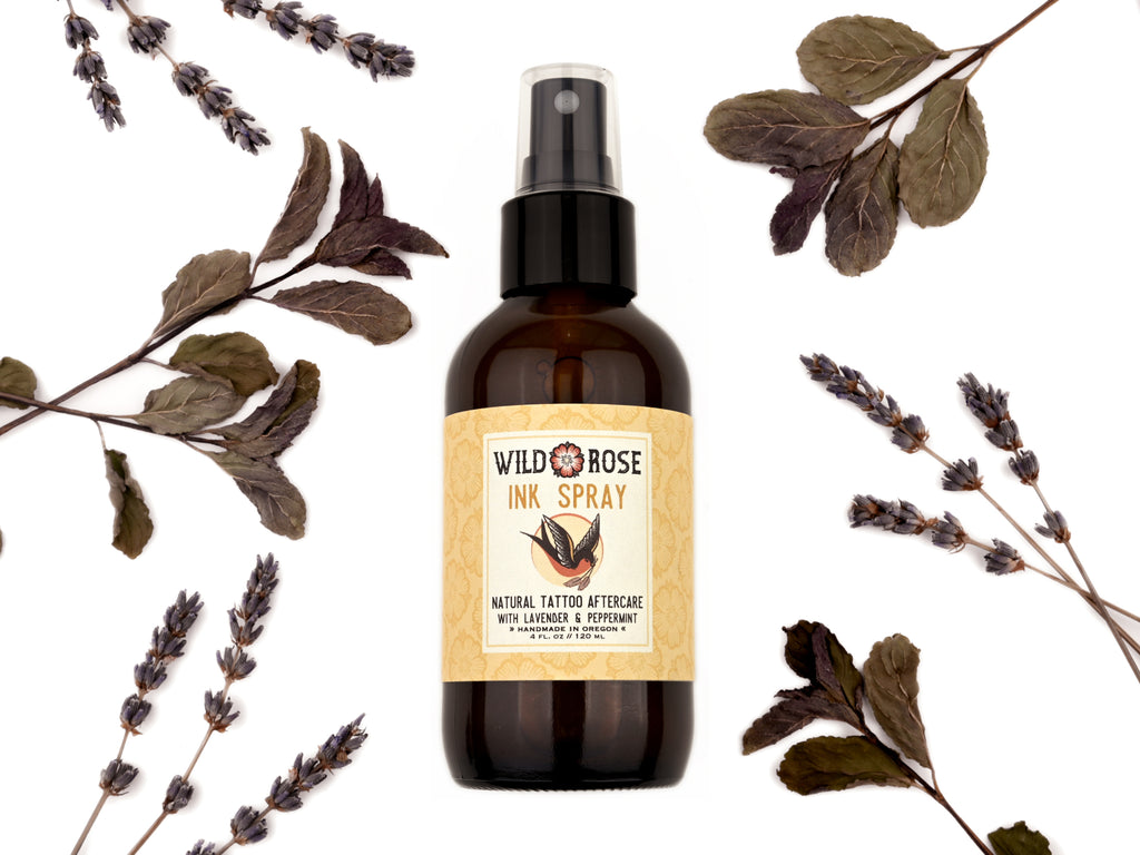 Ink Spray Natural Tattoo Aftercare in a 4oz amber spray bottle. Dried lavender and peppermint surround.