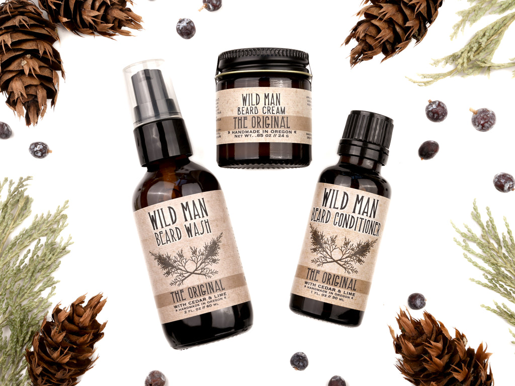 Wild Man beard care set in The Original scent with 30ml Beard Conditioner, 2oz Beard Wash and 1oz Beard Cream. Cedar, fir cones and juniper berries surround.
