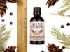 Wild Man Beard Conditioner in The Original scent shown in a 50ml amber glass bottle. Shown next to ruler measuring about 4" tall. Cedar, fir cones and juniper berries surround.