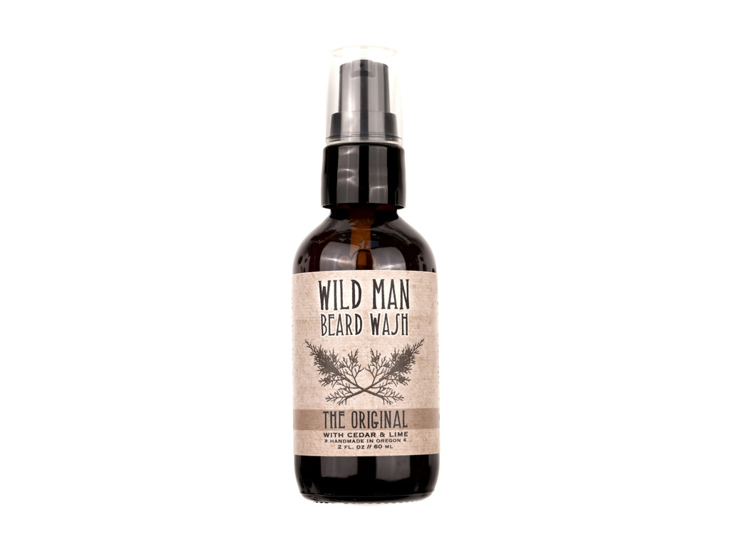 Wild Man Beard Wash in The Original scent shown in a 2oz amber glass bottle on a white background.