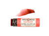 Wild Rose Raspberry Botanical Lip & Cheek Tint in a biodegradable paper tube on a white background. The cap is removed and a color swatch is above, revealing a dark red tint.