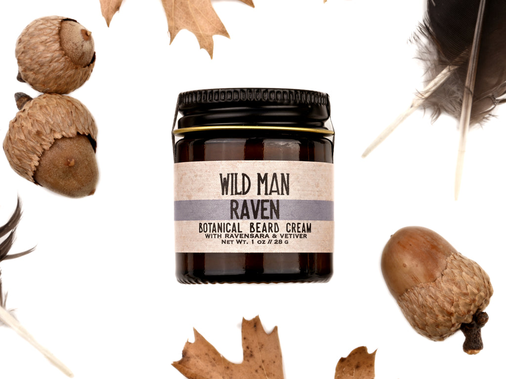 Wild Man Beard Cream - Raven scent in 1oz amber glass jar. Black feathers, acorns and dried oak leaves surround. 
