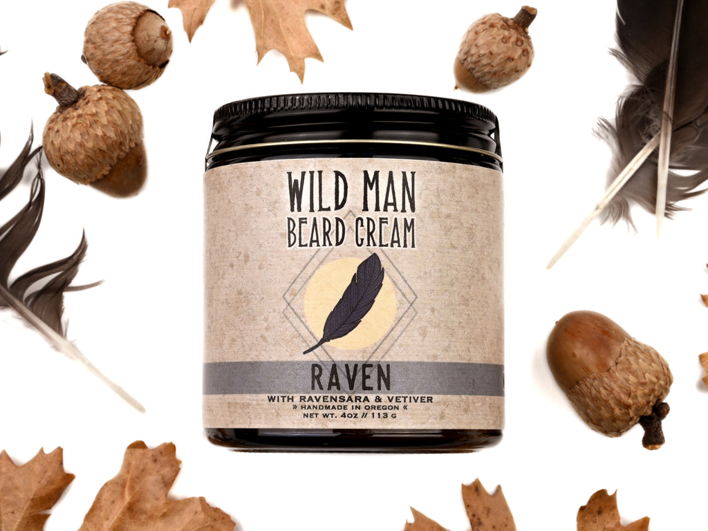 Wild Man Beard Cream - Raven scent in 4oz amber glass jar. Black feathers, acorns and dried oak leaves surround. 