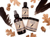 Wild Man beard care set in Raven scent with 50ml Beard Conditioner, 4oz Beard Wash and 4oz Beard Cream. Black feathers, acorns and dried oak leaves surround.