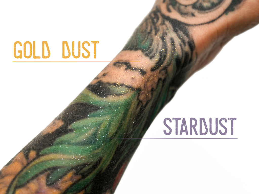 Biodegradable Glitter Stix product shown applied to a tattooed arm. Gold Dust and Stardust colors shown.