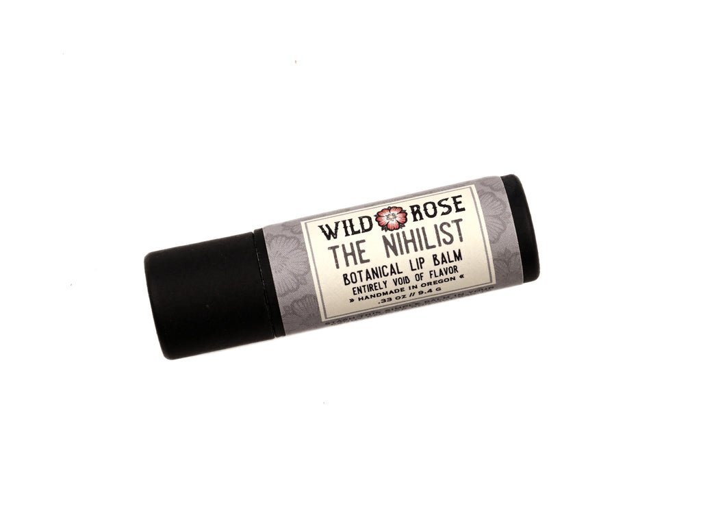 The Nihilist Unflavored Lip Balm in a biodegradable paper tube on a white background. 