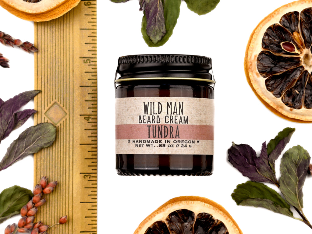 Wild Man Beard Softening Cream Tundra scent in 1oz amber glass jar. Shown with ruler at about 2" tall. Lemon slices and peppermint leaves surround.