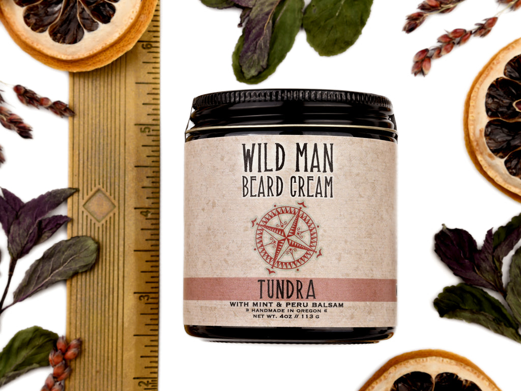 Wild Man Beard Softening Cream Tundra scent in 4oz amber glass jar. Shown with ruler at about 3" tall. Lemon slices and peppermint leaves surround.