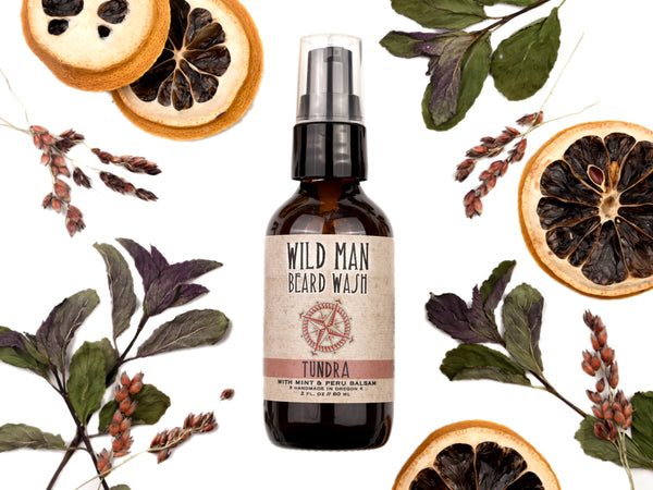 Wild Man Beard Wash Tundra scent in 2oz amber glass bottle. Lemon slices and peppermint leaves surround.