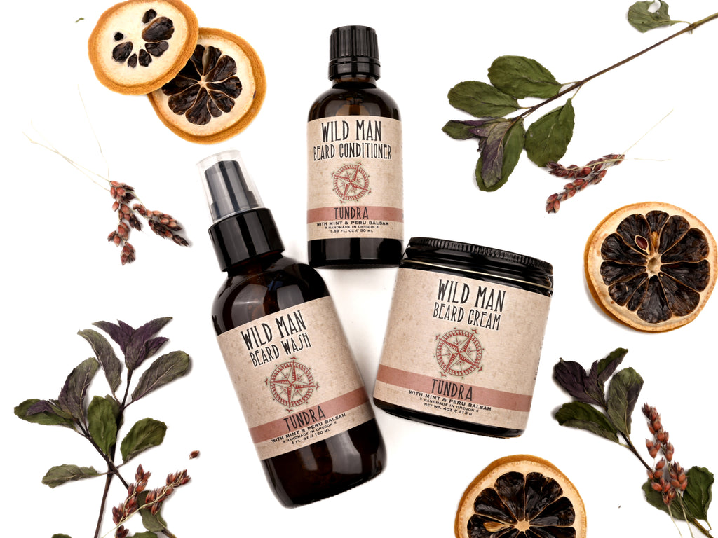 Wild Man beard care set in Tundra scent with 50ml Beard Conditioner, 4oz Beard Wash and 4oz Beard Cream. Lemon slices and peppermint leaves surround.