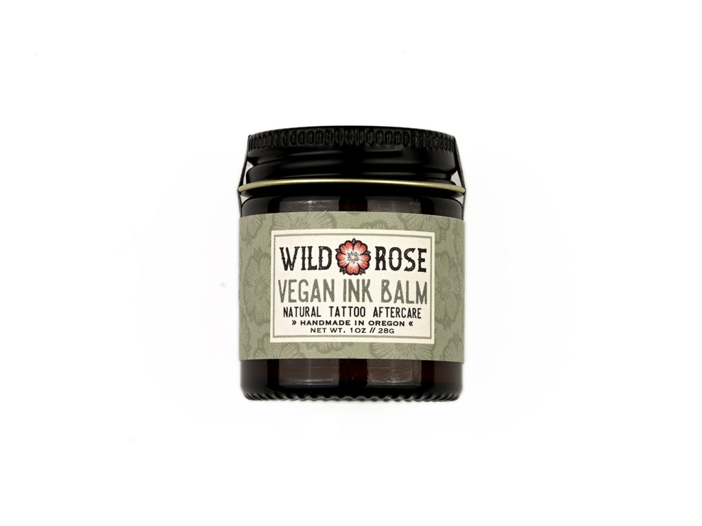 Vegan Ink Balm Natural Tattoo Aftercare in a 1oz amber glass jar with metal lid on a white background.