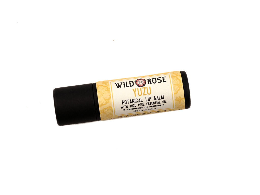 Yuzu Lip Balm in a biodegradable paper tube on a white background.