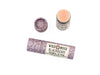 Blackberry Natural Lip Balm in a biodegradable paper tube on a white background. The cap is off revealing a creamy soft pink balm. 