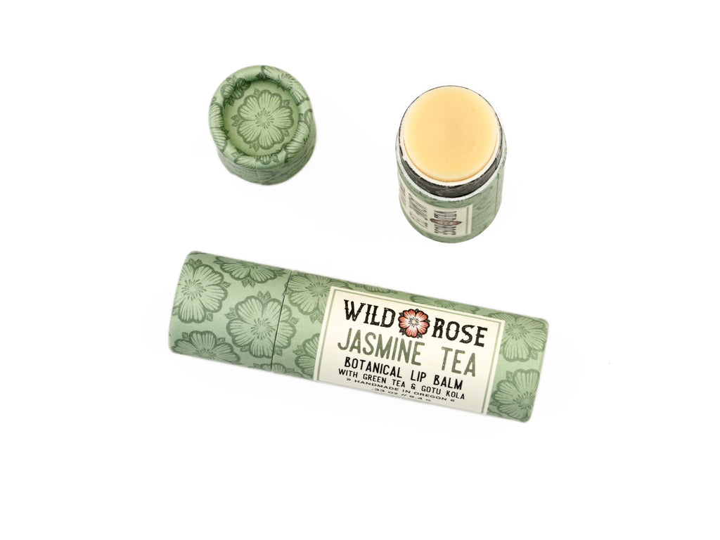 Jasmine Tea Natural Lip Balm in a biodegradable paper tube on a white background. The cap is off, revealing a creamy off-white balm.