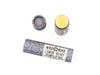 Wild Rose Lemon Berry Botanical Lip Balm in a biodegradable tube on a white background. The cap is removed revealing a creamy yellow balm.