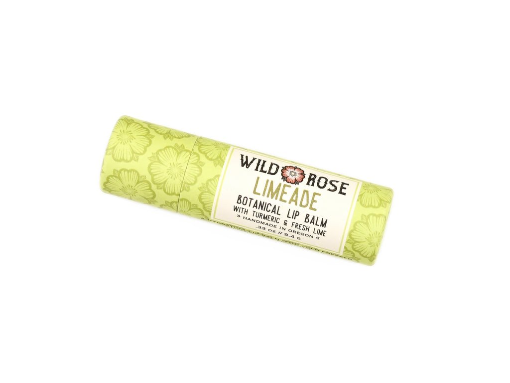 Wild Rose Limeade Botanical Lip Balm in a biodegradable tube on a white background.