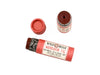 Wild Rose Mandarin Fig Botanical Lip & Cheek Tint in a biodegradable tube on a white background with fresh figs surrounding. The cap is removed revealing a dark red creamy tinted balm.