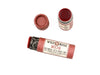 Wild Rose Mocha Botanical Lip & Cheek Tint in a biodegradable paper tube on a white background. The cap is removed, revealing a dark red tint.