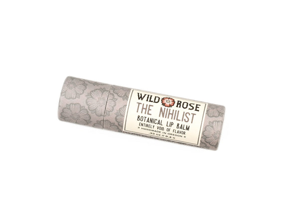 Wild Rose Nihilist Botanical Lip Balm in a biodegradable tube on a white background.