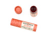 Wild Rose Roseberry Botanical Lip & Cheek Tint in a biodegradable tube on a white background. The cap is removed revealing a creamy soft red tint.
