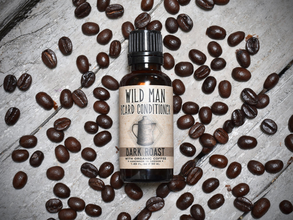 Wild Man Beard Oil Conditioner 30ml amber glass bottle in Dark Roast scent. Coffee beans surround.