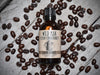 Wild Man Beard Oil Conditioner 50ml amber glass bottle in Dark Roast scent. Coffee beans surround.