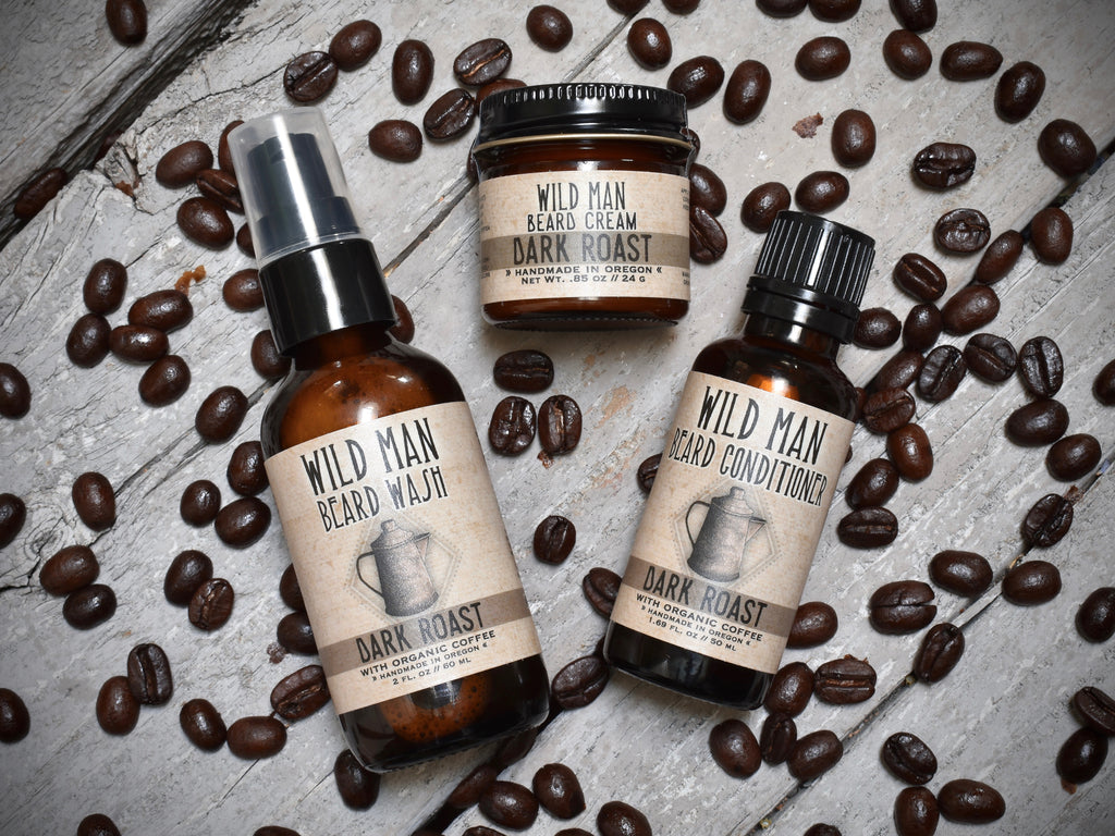 Wild Man beard care set in Dark Roast scent with 30ml Beard Conditioner, 2oz Beard Wash and 1oz Beard Cream. Coffee beans surround.