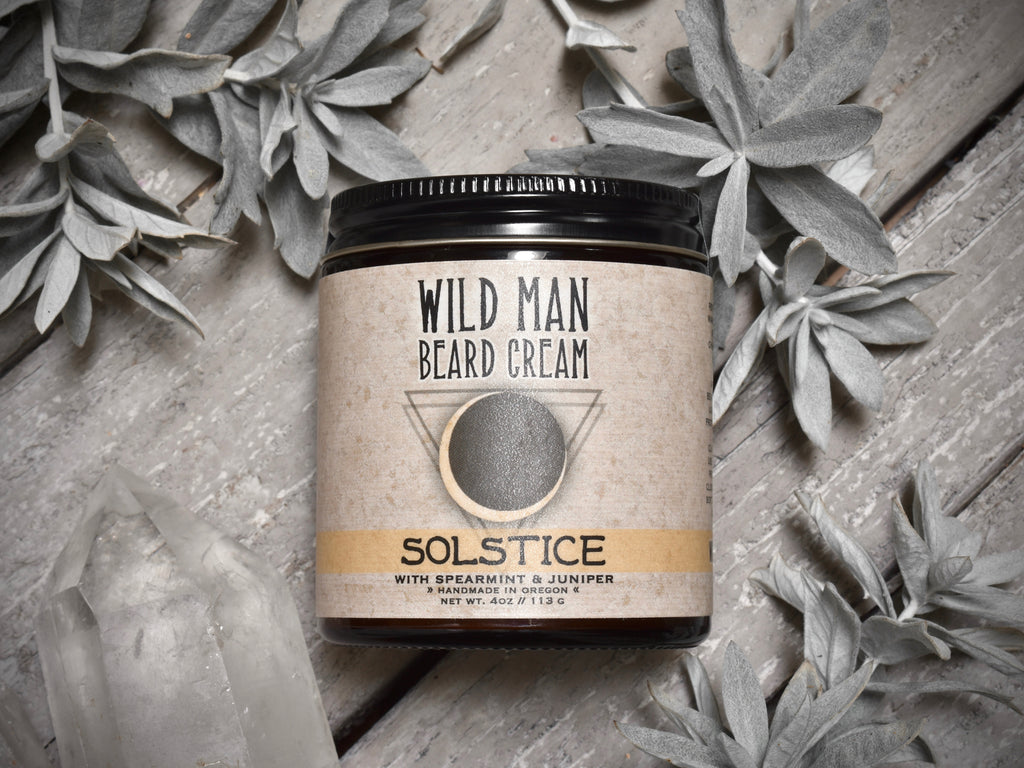 Wild Man Beard Softening Cream Solstice in 4oz amber glass jar. Mugwort leaves and quartz crystals surround.