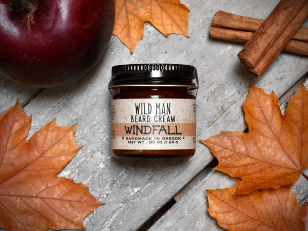 Wild Man Softening Beard Cream Windfall in 1oz amber glass jar. Apples and cinnamon sticks surround.