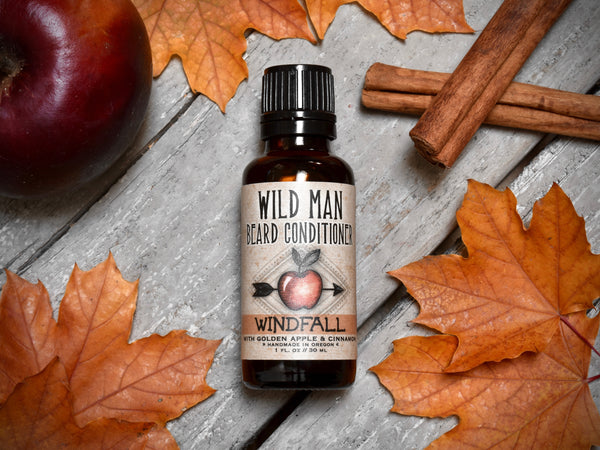 Wild Man Beard Oil Conditioner Windfall in 30ml amber glass botle. Apples and cinnamon sticks surround.