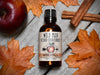 Wild Man Beard Oil Conditioner Windfall in 50ml amber glass bottle. Apples and cinnamon sticks surround.