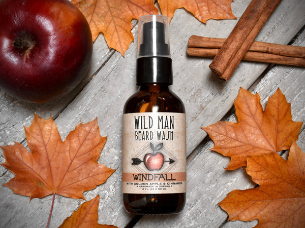 Wild Man Beard Wash Windfall in 2oz amber glass bottle. Apples and cinnamon sticks surround.