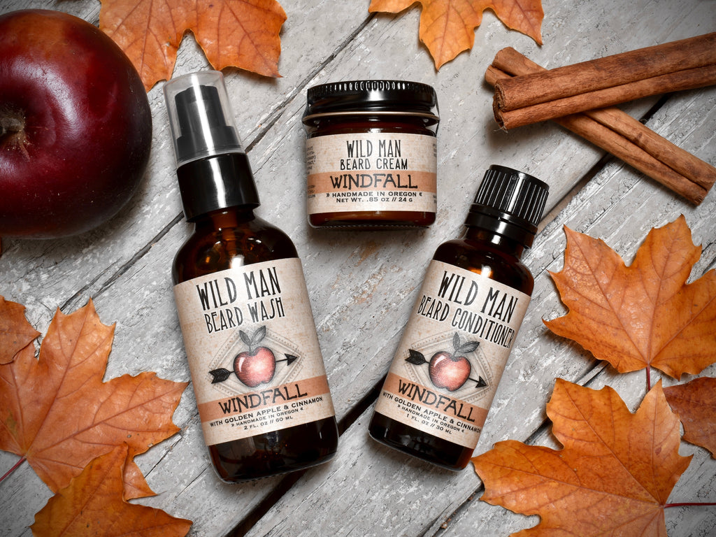 Wild Man beard care set in Windfall scent with 30ml Beard Conditioner, 2oz Beard Wash and 1oz Beard Cream. Apples and cinnamon sticks surround.