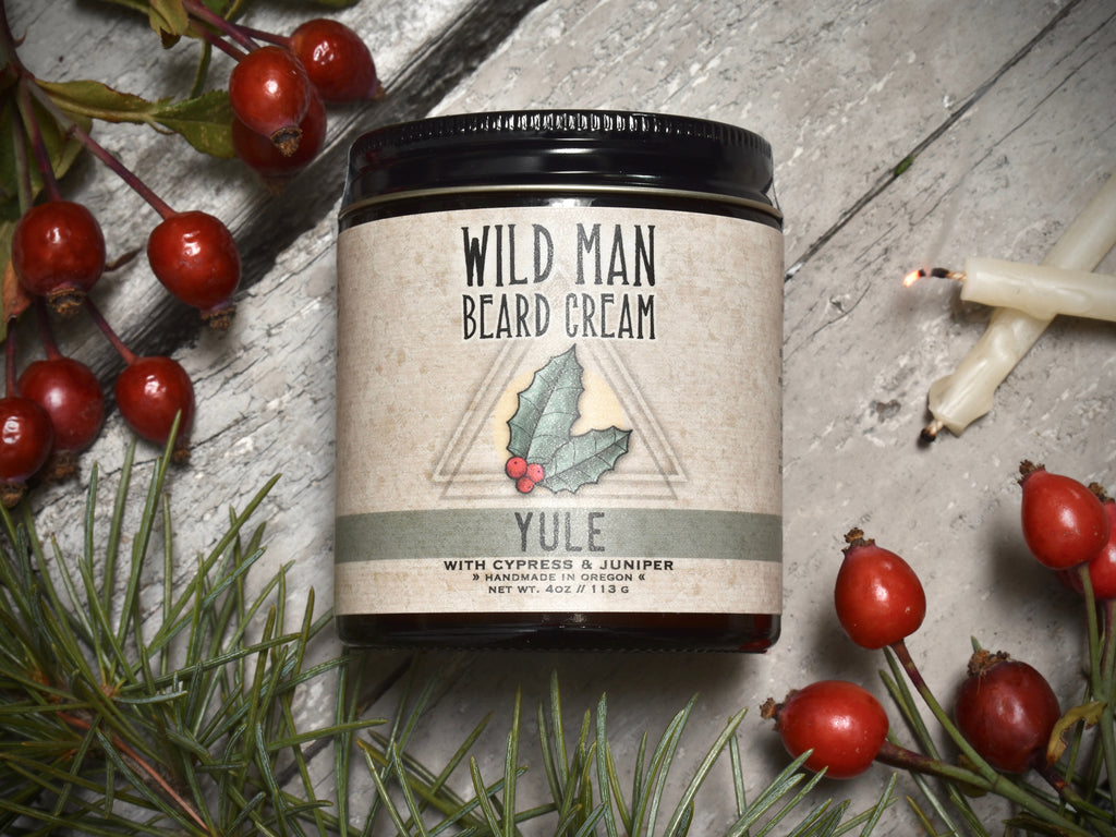 Wild Man Beard Softening Cream 4oz amber glass jar in Yule scent. Rosehips and pine boughs surround.