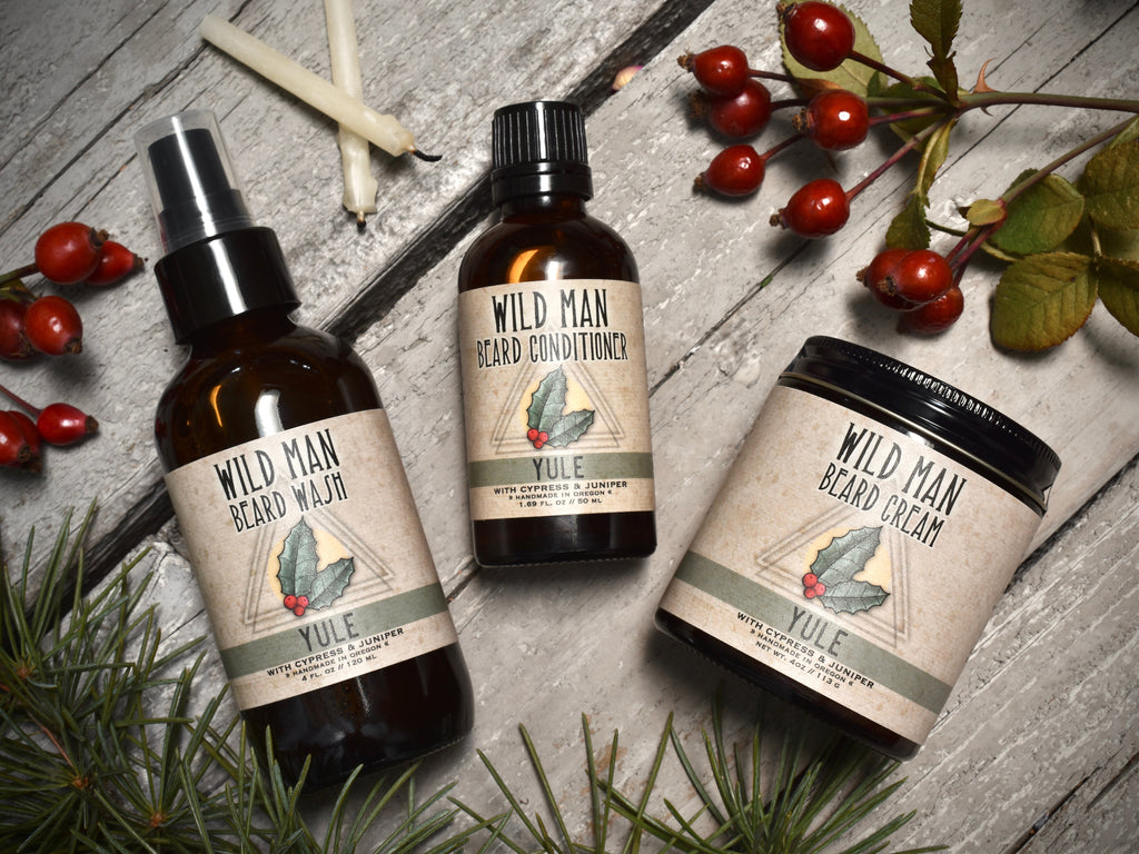 Wild Man beard care set in Yule scent with 50ml Beard Conditioner, 4oz Beard Wash and 4oz Beard Cream. Rosehips and pine boughs surround.